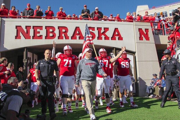 Nebraska head coach Bo Pelini leads his players onto the field before an NCAA college football game against Northwestern, in Lincoln, Neb., Saturday, Nov. 2, 2013. (AP Photo/Nati Harnik)