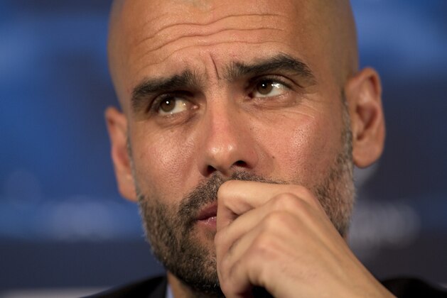 Bayern Munich's head coach Pep Guardiola listens to a question during a press conference in London, Tuesday, Feb. 18 ,2014, ahead of their round of 16 Champions League soccer match against Arsenal on Wednesday. (AP Photo/Alastair Grant)