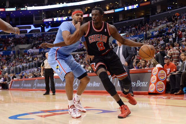 LOS ANGELES, CA - NOVEMBER 24:  Luol Deng #9 of the Chicago Bulls dribbles to the basket against Jared Dudley #9  of the Los Angeles Clippers at Staples Center on November 24, 2013 in Los Angeles, California. NOTE TO USER: User expressly acknowledges and agrees that, by downloading and/or using this Photograph, user is consenting to the terms and conditions of the Getty Images License Agreement. Mandatory Copyright Notice: Copyright 2013 NBAE (Photo by Noah Graham/NBAE via Getty Images)