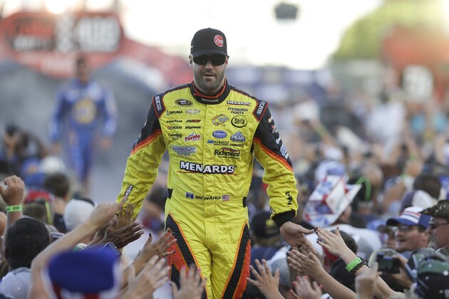 Paul Menard greets fans during driver introductions prior to the start of the NASCAR Sprint Cup auto race at Daytona International Speedway, Saturday, July 6, 2013, in Daytona Beach, Fla. (AP Photo/John Raoux)