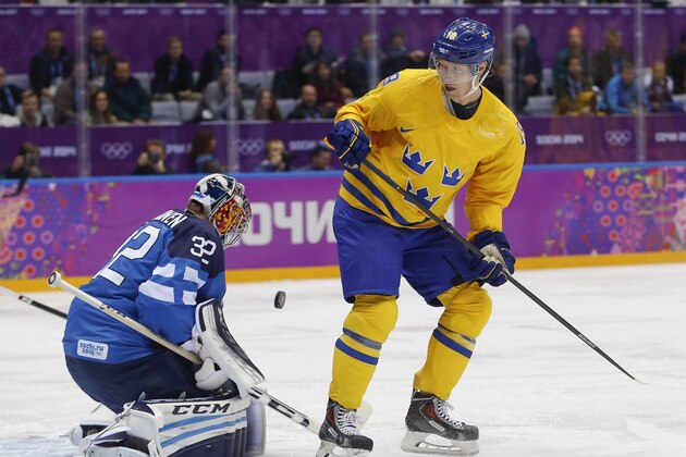 Finland goalkeeper Kari Lehtonen blocks a shot off a rebound by Sweden forward Nicklas Backstrom during the first period of a men's semifinal ice hockey game at the 2014 Winter Olympics, Friday, Feb. 21, 2014, in Sochi, Russia. (AP Photo/Petr David Josek)