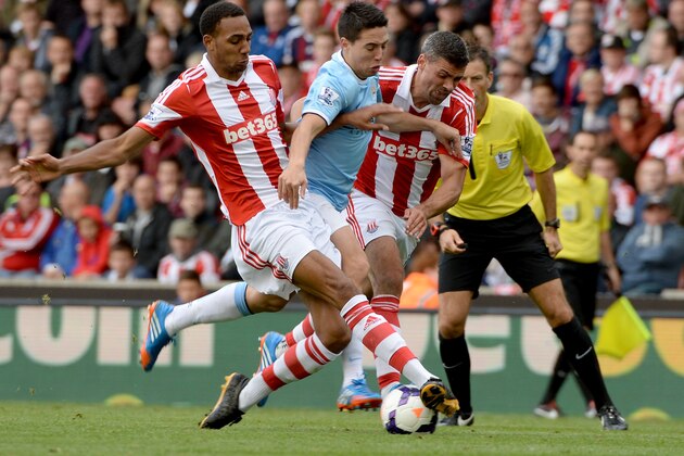 STOKE ON TRENT, ENGLAND - SEPTEMBER 14:   Samir Nasri of Manchester City is challenged by Steven Nzonzi of Stoke during the Barclays Premier League match between Stoke City and Manchester City at the Britannia Stadium on September 14, 2013 in Stoke on Trent, England.  (Photo by Ross Kinnaird/Getty Images)