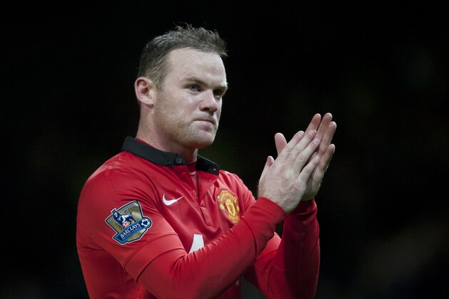 Manchester United's Wayne Rooney applauds supporters as he walks from the pitch after his team's 2-1 loss to Tottenham in their English Premier League soccer match at Old Trafford Stadium, Manchester, England, Wednesday Jan. 1, 2014. (AP Photo/Jon Super)