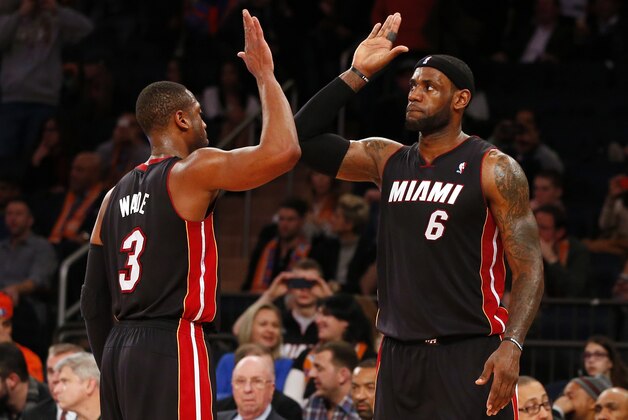 NEW YORK, NY - FEBRUARY 1: Dwyane Wade #3 and LeBron James #6 of the Miami Heat congratulate each other in the closing seconds of a game against the New York Knicks at Madison Square Garden on February. 1, 2014 in New York City. The Heat defeated the Knicks 106-91. NOTE TO USER: User expressly acknowledges and agrees that, by downloading and/or using this Photograph, user is consenting to the terms and conditions of the Getty Images License Agreement. (Photo by Rich Schultz /Getty Images)