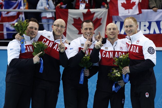 Canada's curlers, from left, Caleb Flaxey, Ryan Harnden, E.J. Harnden, Ryan Fry, and Brad Jacobs pose during flower ceremony after winning the men's curling gold medal at the 2014 Winter Olympics, Friday, Feb. 21, 2014, in Sochi, Russia. (AP Photo/Robert F. Bukaty)
