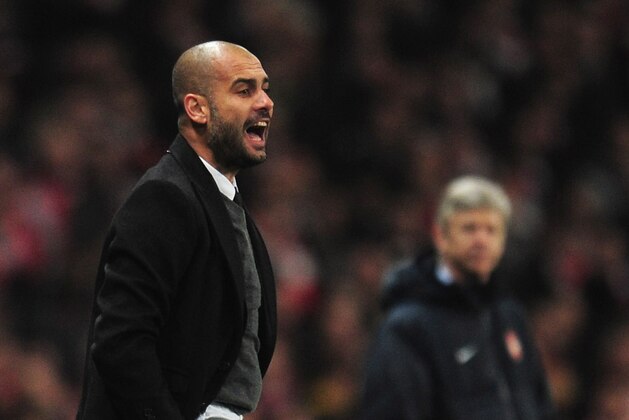 LONDON, ENGLAND - FEBRUARY 16: Josep Guardiola, Coach of Barcelona watches with Arsene Wenger, Manager of Arsenal during the UEFA Champions League round of 16 first leg match between Arsenal and Barcelona at the Emirates Stadium on February 16, 2011 in London, England.  (Photo by Shaun Botterill/Getty Images)