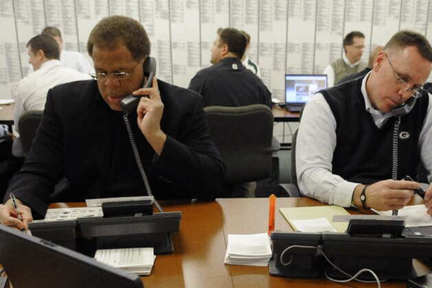 Green Bay Packers director of football operations Reggie McKenzie, left, and director of college scouting John Dorsey work the phones  the phones in the war room  at Lambeau Field for the NFL football draft, Thursday, April 22, 2010, in Green Bay, Wis. (AP Photo/Evan Siegle, Pool) ** POOL PHOTO **