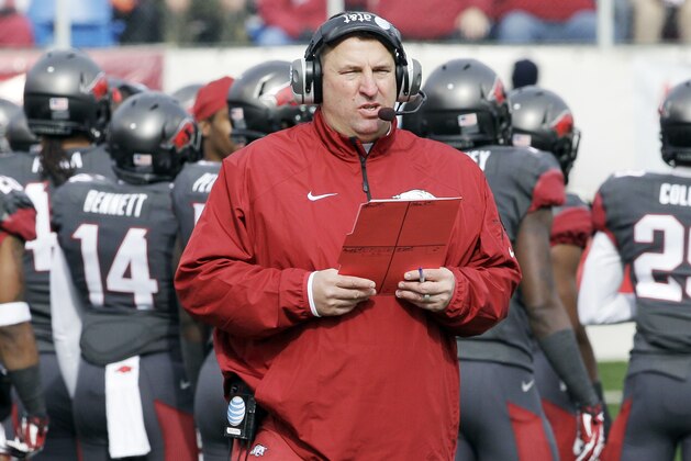 FILE - In this Nov. 23, 2013, file photo, Arkansas coach Bret Bielema walks onto the field in the first half of an NCAA college football game against Mississippi State in Little Rock, Ark. After a 3-9 season, the worst in school history, Bielema has seen the SEC West up close and personal, but he's not about to lower where he thinks the Razorbacks are headed. (AP Photo/Danny Johnston, File)