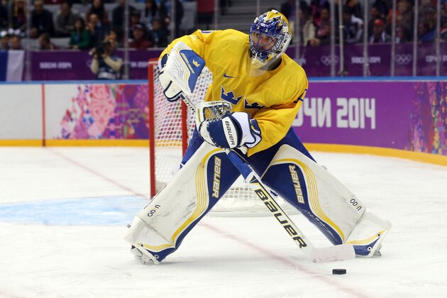 Feb 14, 2014; Sochi, RUSSIA; Sweden goalie Henrik Lundqvist (30) controls the puck against Switzerland in a men's preliminary round ice hockey game during the Sochi 2014 Olympic Winter Games at Bolshoy Ice Dome. Mandatory Credit: Winslow Townson-USA TODAY Sports