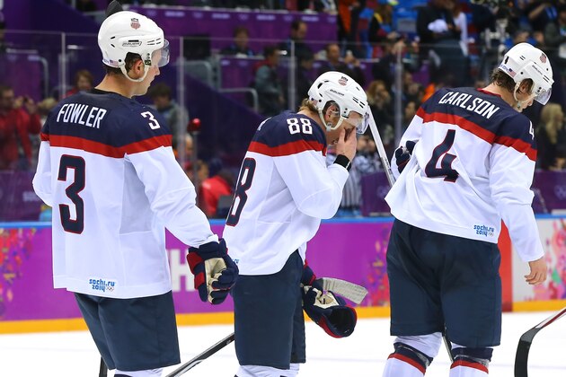 SOCHI, RUSSIA - FEBRUARY 21:  Cam Fowler #3, Patrick Kane #88 and John Carlson #4 of the United States react after losing 1-0 to Canada during the Men's Ice Hockey Semifinal Playoff on Day 14 of the 2014 Sochi Winter Olympics at Bolshoy Ice Dome on February 21, 2014 in Sochi, Russia.  (Photo by Martin Rose/Getty Images)