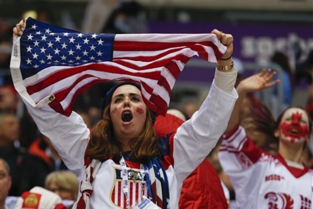 American and Canadian hockey fans cheer as Canada and the USA warm up before playing in a men's semifinal ice hockey game at the 2014 Winter Olympics, Friday, Feb. 21, 2014, in Sochi, Russia. (AP Photo/Petr David Josek)
