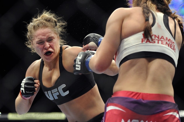 Ronda Rousey, left, of Venice, Calif., punches Miesha Tate of Yakima, Wash., during the UFC 168 mixed martial arts women's bantamweight title fight on Saturday, Dec. 28, 2013, in Las Vegas. Rousey won by a third round tap out. (AP Photo/David Becker) Ronda Rousey, left, of Venice, Calif., punches Miesha Tate of Yakima, Wash., during the UFC 168 mixed martial arts women's bantamweight title fight on Saturday, Dec. 28, 2013, in Las Vegas. Rousey won by a third round tap out. (AP Photo/David Becker)