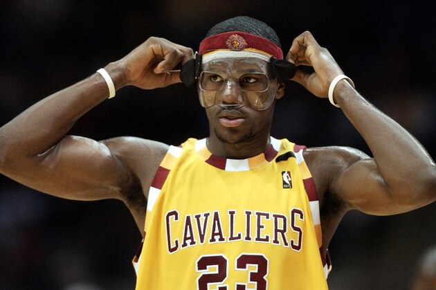 Cleveland Cavaliers' LeBron James (23) adjusts his mask after a timeout in the second quarter against the New York Knicks Saturday, Jan. 8, 2005, in Cleveland. (AP Photo/Tony Dejak)