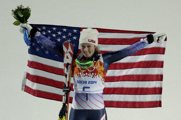 Women's gold medalist, United States' Mikaela Shiffrin, celebrates during the flower ceremony for the women's slalom at the Sochi 2014 Winter Olympics, Friday, Feb. 21, 2014, in Krasnaya Polyana, Russia. (AP Photo/Charlie Riedel)