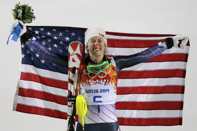 Women's slalom gold medal winner Mikaela Shiffrin of the United States poses for photographers with the American flag at the Sochi 2014 Winter Olympics, Friday, Feb. 21, 2014, in Krasnaya Polyana, Russia.(AP Photo/Christophe Ena)
