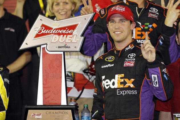 Denny Hamlin celebrates in Victory Lane after winning the second of two NASCAR Sprint Cup series qualifying auto races at Daytona International Speedway in Daytona Beach, Fla., Thursday, Feb. 20, 2014. (AP Photo/Terry Renna)