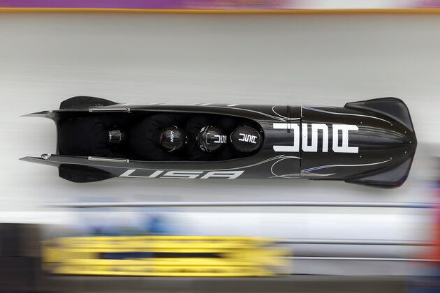 The team from the United States USA-1, piloted by Steven Holcomb, take a curve during the men's four-man bobsled training at the 2014 Winter Olympics, Friday, Feb. 21, 2014, in Krasnaya Polyana, Russia. (AP Photo/Michael Sohn)
