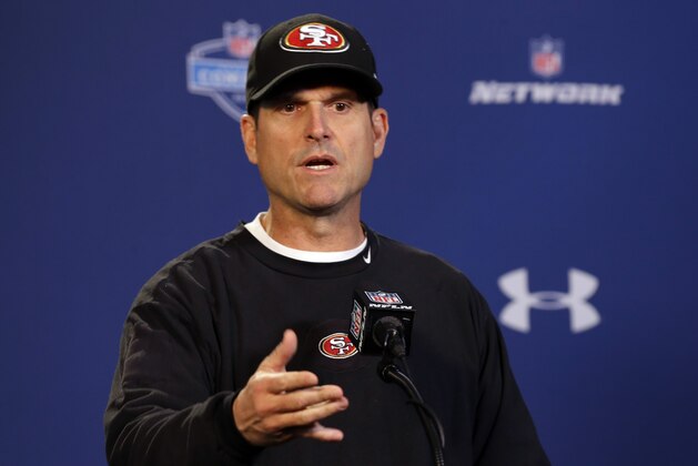 San Francisco 49ers head coach Jim Harbaugh answers a question during a news conference at the NFL football scouting combine in Indianapolis, Thursday, Feb. 20, 2014. (AP Photo/Michael Conroy)
