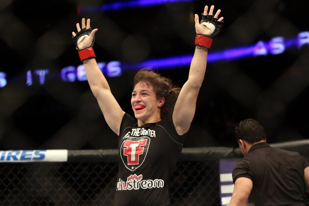Sara McMann celebrates her win over Sheila Gaff after their UFC 159 Mixed Martial Arts bout in Newark, NJ, Saturday, April 27,2013.  McMann won via first round TKO. (AP Photo/Gregory Payan)