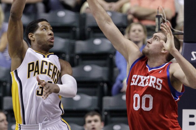 Indiana Pacers forward Danny Granger, left, shoots over Philadelphia 76ers center Spencer Hawes in the first half of an NBA basketball game in Indianapolis, Wednesday, March 14, 2012. (AP Photo/Michael Conroy)