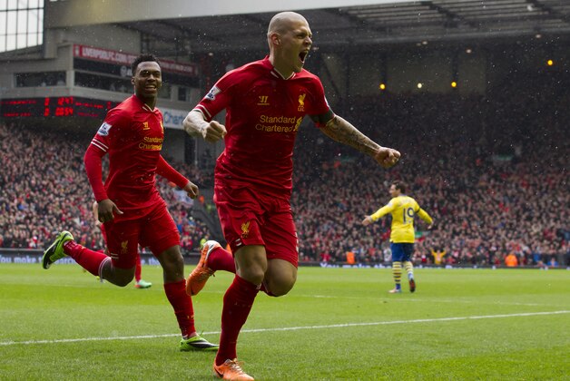 Liverpool's Martin Skrtel, centre, celebrates after scoring his first goal against Arsenal during their English Premier League soccer match at Anfield Stadium, Liverpool, England, Saturday Feb. 8, 2014. (AP Photo/Jon Super)