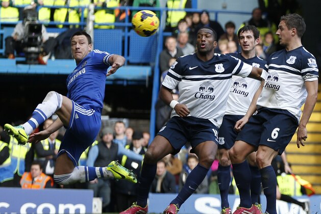 Chelsea's captain John Terry, left, jumps to control the ball to go on and score against Everton during an English Premier League soccer match at the Stamford Bridge ground in London, Saturday, Feb. 22, 2014. Chelsea won the match 1-0. (AP Photo/Lefteris Pitarakis)