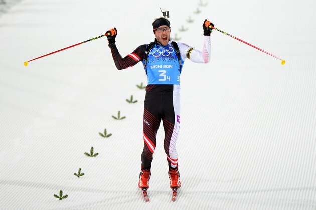 SOCHI, RUSSIA - FEBRUARY 22:  Bronze medalist Dominik Landertinger of Austria celebrates as he approaches the finish line during the Men's 4 x 7.5 km Relay during day 15 of the Sochi 2014 Winter Olympics at Laura Cross-country Ski & Biathlon Center on February 22, 2014 in Sochi, Russia.  (Photo by Harry How/Getty Images)