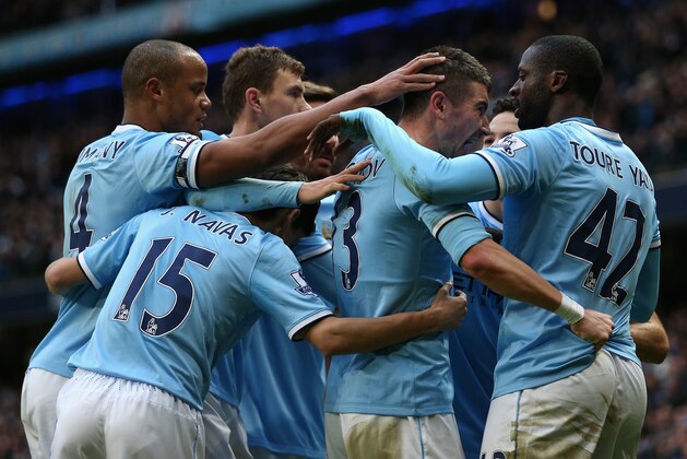 MANCHESTER, ENGLAND - FEBRUARY 22:  Yaya Toure of Manchester City celebrates scoring the opening goal with his team-mates during the Barclays Premier League match between Manchester City and Stoke City at the Etihad Stadium on February 22, 2014 in Manchester, England.  (Photo by Clive Brunskill/Getty Images)