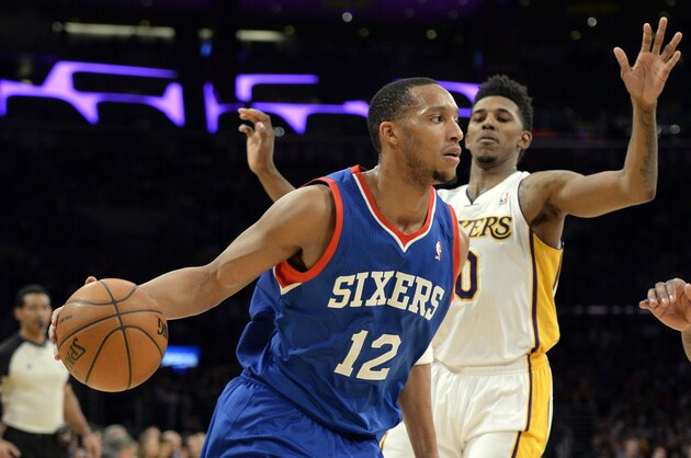 Dec 29, 2013; Los Angeles, CA, USA; Philadelphia 76ers small forward Evan Turner (12) drives past Los Angeles Lakers small forward Nick Young (0) during the second quarter at Staples Center. Mandatory Credit: Richard Mackson-USA TODAY Sports