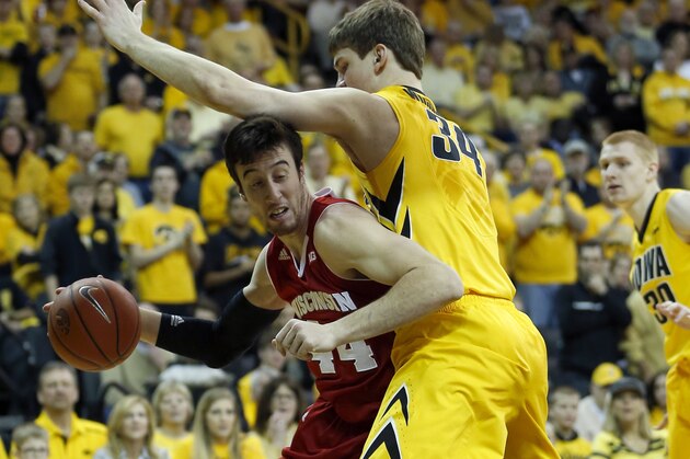 Wisconsin forward Frank Kaminsky tries to go around Iowa center Adam Woodbury during the first half of an NCAA college basketball game in Iowa City, Iowa, Saturday, Feb. 22, 2014. (AP Photo/Justin Hayworth)