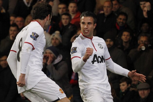 Manchester United's Robin Van Persie, right, celebrates his penalty goal against Crystal Palace with teammate Juan Mata during their English Premier League soccer match at Selhurst Park, London, Saturday, Feb. 22, 2014. (AP Photo/Sang Tan)