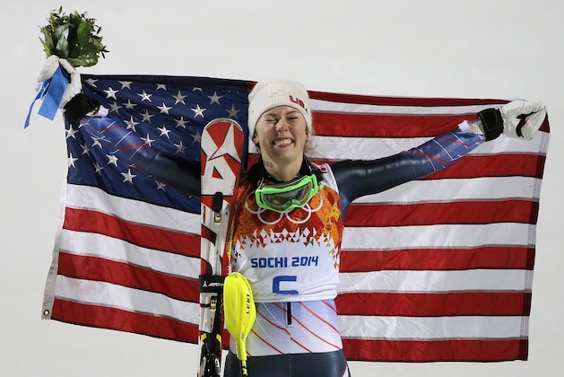 Women's slalom gold medal winner Mikaela Shiffrin of the United States poses for photographers with the American flag at the Sochi 2014 Winter Olympics, Friday, Feb. 21, 2014, in Krasnaya Polyana, Russia.(AP Photo/Christophe Ena)