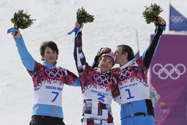 Men's snowboard parallel slalom gold medalist Vic Wild of Russia, center, is kissed by bronze medalist Benjamin Karl, right, as silver medalist Zan Kosir of Slovenia, left, celebrates, at the Rosa Khutor Extreme Park, at the 2014 Winter Olympics, Saturday, Feb. 22, 2014, in Krasnaya Polyana, Russia. (AP Photo/Andy Wong) Men's snowboard parallel slalom gold medalist Vic Wild of Russia, center, is kissed by bronze medalist Benjamin Karl, right, as silver medalist Zan Kosir of Slovenia, left, celebrates, at the Rosa Khutor Extreme Park, at the 2014 Winter Olympics, Saturday, Feb. 22, 2014, in Krasnaya Polyana, Russia. (AP Photo/Andy Wong)