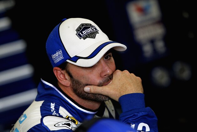 DAYTONA BEACH, FL - FEBRUARY 22:  Jimmie Johnson, driver of the #48 Lowe's Chevrolet, stands in the garage area during practice for the NASCAR Sprint Cup Series Daytona 500 at Daytona International Speedway on February 22, 2014 in Daytona Beach, Florida.  (Photo by Sean Gardner/Getty Images)