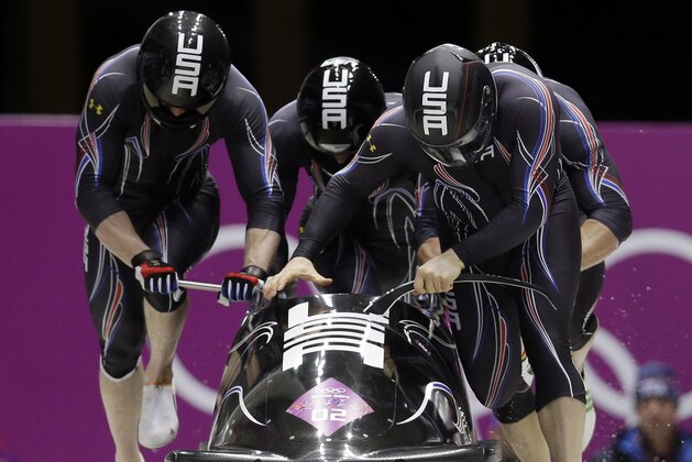 The team from the United States USA-1, with Steven Holcomb, Curtis Tomasevicz, Steven Langton and Christopher Fogt, start their first run during the men's four-man bobsled competition at the 2014 Winter Olympics, Saturday, Feb. 22, 2014, in Krasnaya Polyana, Russia. (AP Photo/Natacha Pisarenko)