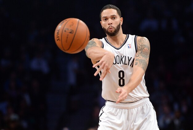 Feb 6, 2014; Brooklyn, NY, USA; Brooklyn Nets point guard Deron Williams (8) makes a pass against the San Antonio Spurs during the first half at Barclays Center. Mandatory Credit: Joe Camporeale-USA TODAY Sports
