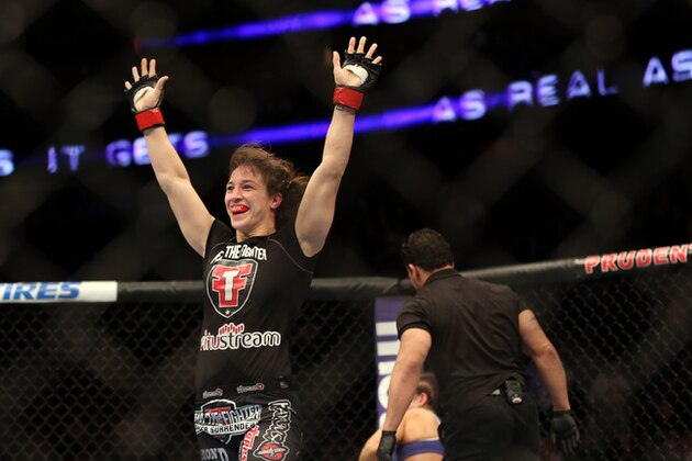 Sara McMann celebrates her win over Sheila Gaff after their UFC 159 Mixed Martial Arts bout in Newark, NJ, Saturday, April 27,2013.  McMann won via first round TKO. (AP Photo/Gregory Payan)