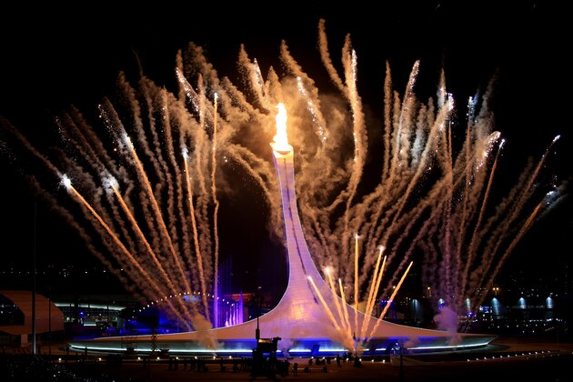 SOCHI, RUSSIA - FEBRUARY 07:  Fireworks explode while the Olympic flame is lit during the Opening Ceremony of the Sochi 2014 Winter Olympics at Fisht Olympic Stadium on February 7, 2014 in Sochi, Russia.  (Photo by Richard Heathcote/Getty Images)