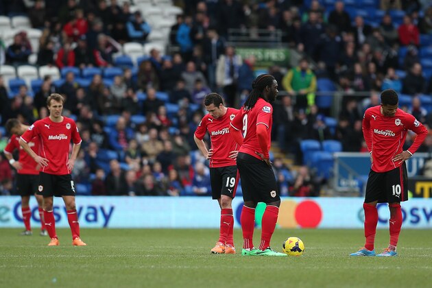 CARDIFF, WALES - FEBUARY 22: Cardiff trio Don Cowie, Kenwyne Jones and Fraizer Campbell look dejected after conceading a fourth goal during the Barclays Premier League match between Cardiff City and Hull City at Cardiff City Stadium on Febuary 22, 2014 in Cardiff, Wales. (Photo by Charlie Crowhurst/Getty Images)