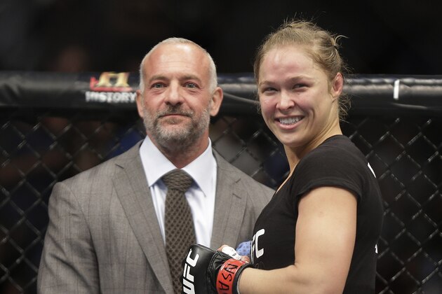 Ronda Rousey, right, smiles with UFC owner Lorenzo Fertitta following her UFC 170 mixed martial arts women's bantamweight title fight against Sara McMann on Saturday, Feb. 22, 2014, in Las Vegas. (AP Photo/Isaac Brekken)