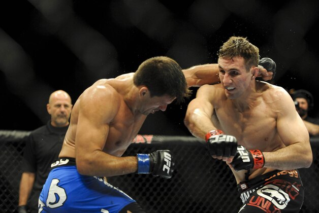Feb 22, 2014; Las Vegas, NV, USA;  Rory MacDonald (red gloves) throws a punch at Demian Maia (blue gloves) during their UFC welterweight bout at Mandalay Bay. MacDonald won by way of a 29-28 decision. Mandatory Credit: Stephen R. Sylvanie-USA TODAY Sports