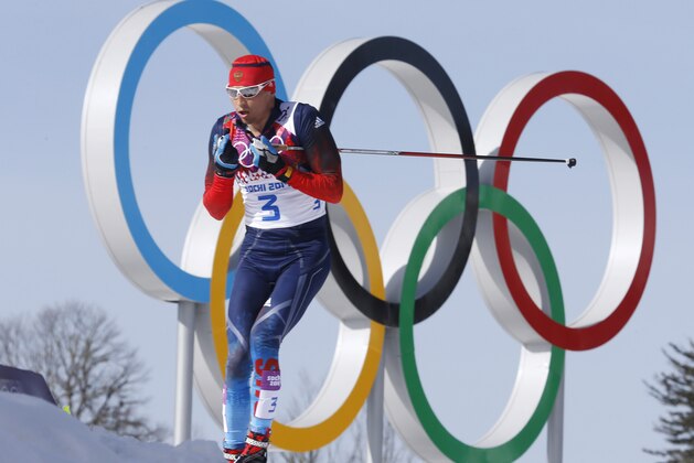 Russia's gold medal winner Alexander Legkov skis past the Olympic rings during the men's 50K cross-country race at the 2014 Winter Olympics, Sunday, Feb. 23, 2014, in Krasnaya Polyana, Russia. (AP Photo/Dmitry Lovetsky)