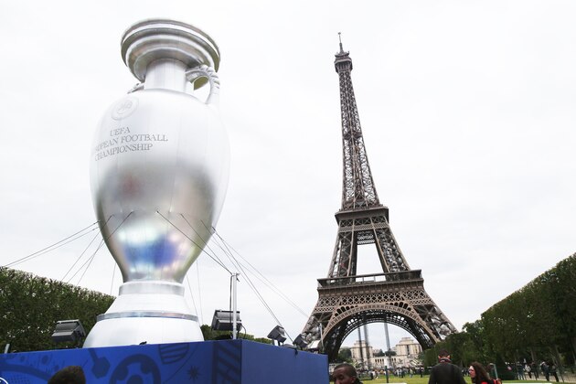 A 12 meters tall replica of the UEFA EURO 2016 trophy, called the Henri Delaunay Cup, displayed in front of the Eiffel Tower in Paris, Monday, June 24, 2013. France will host the UEFA EURO 2016 tournament between June 10 and July 10, 2016. (AP Photo/Michel Euler)