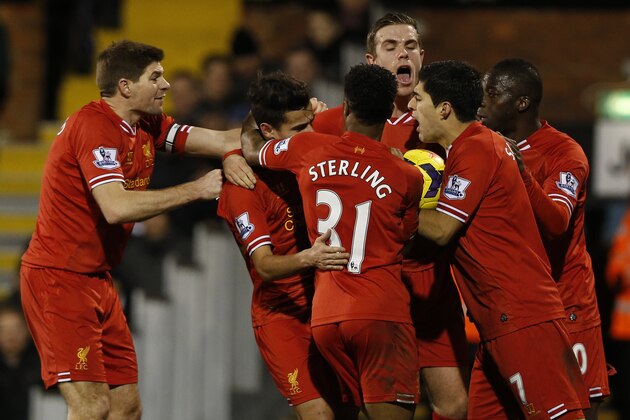 Liverpool's players celebrate Philippe Coutinho's goal against Fulham during their English Premier League soccer match at Craven Cottage, London, Wednesday, Feb. 12, 2014. (AP Photo/Sang Tan)