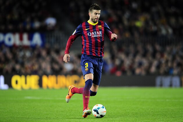 FC Barcelona's Gerard Pique controls the ball against Rayo Vallecano during a Spanish La Liga soccer match at the Camp Nou stadium in Barcelona, Spain, Saturday, Feb. 15, 2014. (AP Photo/Manu Fernandez)
