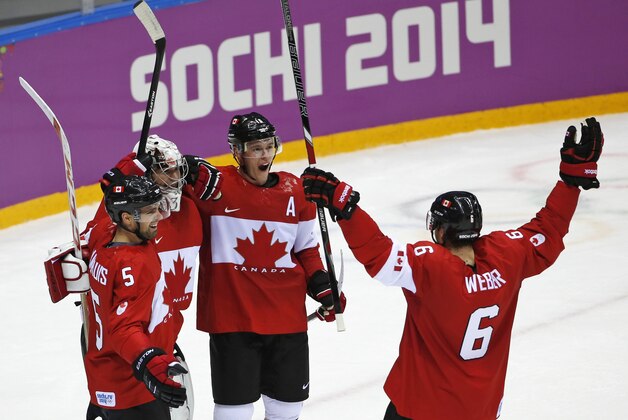 Dan Hamhuis of Canada (5), goalkeeper Carey Price of Canada (31), Jonathan Toews of Canada (16) and Shea Weber of Canada (6) celebrate their 3-0 win over Sweden in the men's gold medal ice hockey game at the 2014 Winter Olympics, Sunday, Feb. 23, 2014, in Sochi, Russia. (AP Photo/Petr David Josek)