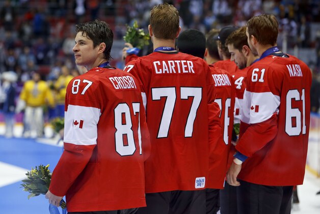 Canada forward Sidney Crosby looks into the grandstand after receiving his gold medal after playing Sweden in the men's gold medal ice hockey game at the 2014 Winter Olympics, Sunday, Feb. 23, 2014, in Sochi, Russia. Canada beat Sweden 3-0. (AP Photo/Matt Slocum)