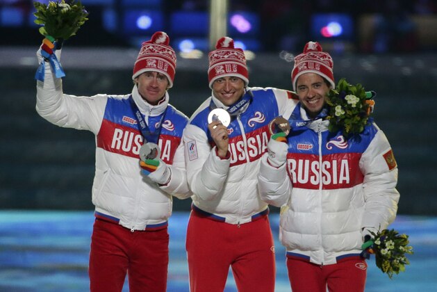 From left, Russia's silver medal winner Maxim Vylegzhanin, Russia's gold medal winner Alexander Legkov and Russia's bronze medal winner Ilia Chernousov pose during the medals ceremony for the men's 50K cross-country race during the closing ceremony of the 2014 Winter Olympics, Sunday, Feb. 23, 2014, in Sochi, Russia. (AP Photo/Charlie Riedel)