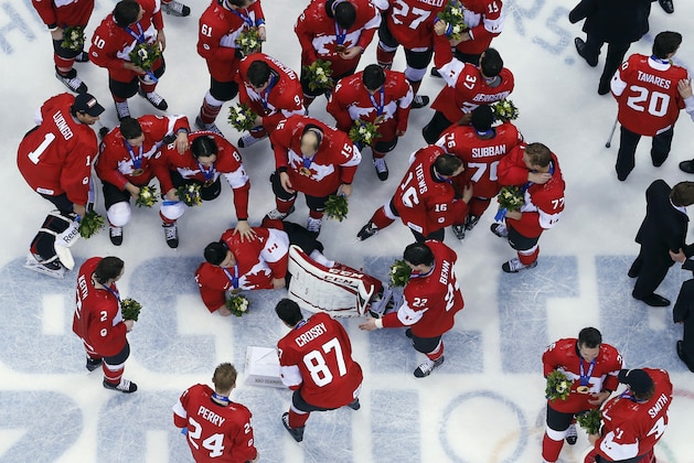Players gather around Canada goaltender Carey Price as they celebrate after the men's gold medal ice hockey game against Sweden at the 2014 Winter Olympics, Sunday, Feb. 23, 2014, in Sochi, Russia. Canada won 3-0 to win the gold medal. (AP Photo/David J. Phillip )
