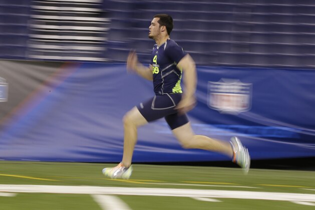 Fresno State quarterback Derek Carr runs the 40-yard dash at the NFL football scouting combine in Indianapolis, Sunday, Feb. 23, 2014. (AP Photo/Michael Conroy)